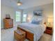 Well-lit bedroom with neutral tones, complemented by a comfortable bed and wood furnishings at 2557 Avery Park Cir, Atlanta, GA 30360