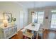Open dining area with lots of windows for natural light and hardwood floors at 2557 Avery Park Cir, Atlanta, GA 30360