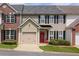 Charming exterior view of a home featuring an attached garage and well-maintained landscaping at 2557 Avery Park Cir, Atlanta, GA 30360