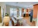 Open concept kitchen and dining area with lots of windows for natural light and hardwood floors at 2557 Avery Park Cir, Atlanta, GA 30360