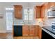 Stylish kitchen featuring wood cabinets, granite countertops, and stainless steel appliances at 2557 Avery Park Cir, Atlanta, GA 30360