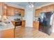 A kitchen with stainless steel appliances, granite countertops, and light wood cabinets with hardwood floors at 2557 Avery Park Cir, Atlanta, GA 30360