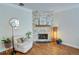 Bright living room featuring a decorative stone fireplace, hardwood floors, and comfortable chair at 2557 Avery Park Cir, Atlanta, GA 30360