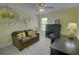 Comfortable living room with a sofa, desk, and ample lighting, perfect for a relaxed atmosphere at 2557 Avery Park Cir, Atlanta, GA 30360