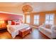 Spacious main bedroom with hardwood floors, sitting area, and decorative lighting at 2557 Avery Park Cir, Atlanta, GA 30360
