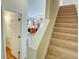 Stairway leading to the second floor with an open view to kitchen and dining area at 2557 Avery Park Cir, Atlanta, GA 30360
