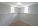 Finished basement area with clean neutral paint, tile floors and natural light from windows at 3009 Bruce Nw Ct, Acworth, GA 30101