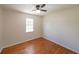 Cozy bedroom with hardwood floors, a ceiling fan, and ample natural light from the window at 3009 Bruce Nw Ct, Acworth, GA 30101
