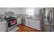 Well-equipped kitchen features stainless steel appliances, white cabinets, and modern fixtures at 3009 Bruce Nw Ct, Acworth, GA 30101