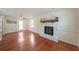 Cozy living room showcasing hardwood floors and a stone fireplace with a wooden mantle at 3009 Bruce Nw Ct, Acworth, GA 30101
