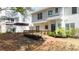 Rear exterior view showing a two story home with a deck, patio and manicured landscaping at 5395 Fontenoy Ct, Peachtree Corners, GA 30071