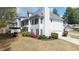 Rear exterior view showing a two story home with a deck, patio and manicured landscaping at 5395 Fontenoy Ct, Peachtree Corners, GA 30071
