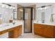 Spacious bathroom featuring a dual sink vanity with framed mirror and glass-enclosed shower at 5395 Fontenoy Ct, Peachtree Corners, GA 30071
