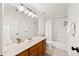 Bathroom boasts a bright vanity and shower-tub combo with white tile and contrasting dark hardware at 5395 Fontenoy Ct, Peachtree Corners, GA 30071