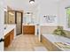 Beautiful primary bathroom featuring a soaking tub, double vanity, and tiled shower at 5395 Fontenoy Ct, Peachtree Corners, GA 30071