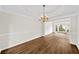 Dining room with elegant chandelier, detailed trim, and hardwood floors at 5395 Fontenoy Ct, Peachtree Corners, GA 30071