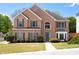 Charming two-story brick home with manicured landscaping, gray shutters, and a welcoming entrance at 5395 Fontenoy Ct, Peachtree Corners, GA 30071