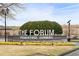 A view of the Forum entrance sign with lush flowers and foliage creating an inviting gateway at 5395 Fontenoy Ct, Peachtree Corners, GA 30071
