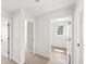 Hallway view shows three entryways and neutral carpet at 5395 Fontenoy Ct, Peachtree Corners, GA 30071