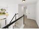Bright hallway features a chandelier, a black railing staircase, and neutral carpet at 5395 Fontenoy Ct, Peachtree Corners, GA 30071