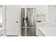 Modern kitchen with stainless steel refrigerator, white cabinets, and marbled countertops at 5395 Fontenoy Ct, Peachtree Corners, GA 30071