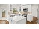 Bright kitchen featuring white cabinets, stainless steel appliances, and a center island at 5395 Fontenoy Ct, Peachtree Corners, GA 30071