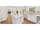 Modern kitchen featuring stainless steel appliances, white cabinets, tile backsplash, and center island at 5395 Fontenoy Ct, Peachtree Corners, GA 30071