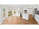 Open-concept kitchen and dining area with white cabinets, stainless appliances, and lots of natural light at 5395 Fontenoy Ct, Peachtree Corners, GA 30071