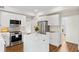 Bright kitchen featuring stainless steel appliances, center island, and white cabinetry at 5395 Fontenoy Ct, Peachtree Corners, GA 30071