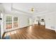 Inviting living room with tray ceilings, large windows, and neutral paint. Hardwood flooring at 5395 Fontenoy Ct, Peachtree Corners, GA 30071