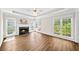 Bright living room featuring a fireplace with marble surround, hardwood floors, and ample natural light at 5395 Fontenoy Ct, Peachtree Corners, GA 30071