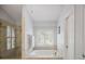 Bright bathroom with a soaking tub, stand up shower, and neutral tile and lighting at 2794 Kakki Ct, Marietta, GA 30062