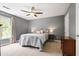 Calm bedroom with ceiling fan, neutral tones, a large window and bedside lamps at 2794 Kakki Ct, Marietta, GA 30062