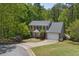 Charming two-story brick home with a lush green lawn and mature trees, showcasing curb appeal at 2794 Kakki Ct, Marietta, GA 30062