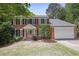 Classic brick home with black shutters, a welcoming front entrance, and an attached two-car garage at 2794 Kakki Ct, Marietta, GA 30062