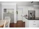 Bright kitchen with stainless steel refrigerator, white cabinets, dark counters, kitchen island and hardwood floors at 2794 Kakki Ct, Marietta, GA 30062