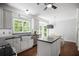 Eat-in kitchen area with a stainless steel sink, stainless appliances, white cabinets and island with seating at 2794 Kakki Ct, Marietta, GA 30062