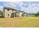 Spacious backyard with well-maintained lawn, covered patio and view of neighboring homes at 311 Wells Cir, Canton, GA 30114