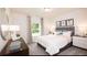 Serene bedroom with neutral tones, large window, and comfortable furnishings, creating a relaxing retreat at 311 Wells Cir, Canton, GA 30114