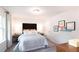 Modern bedroom with neutral colors, stylish bedside tables, and natural light from a large window at 311 Wells Cir, Canton, GA 30114