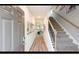 Inviting entryway with staircase, wood floors, and view into the open concept living area at 311 Wells Cir, Canton, GA 30114