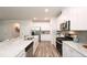 Modern kitchen featuring white cabinetry, stainless steel appliances, and a spacious center island at 311 Wells Cir, Canton, GA 30114