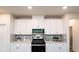 Well-equipped kitchen with stainless steel appliances, ample white cabinetry, and modern countertops at 311 Wells Cir, Canton, GA 30114