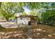 Back exterior of home featuring screened porch, patio, and mature landscaping at 324 Pine Ne St, Marietta, GA 30060