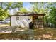 Back exterior of home featuring screened porch, patio, and mature landscaping at 324 Pine Ne St, Marietta, GA 30060