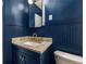 Stylish bathroom features blue wainscoting, granite countertops, a modern sink and a vanity mirror at 324 Pine Ne St, Marietta, GA 30060