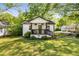 Bungalow-style home boasts a lush green lawn and a inviting front porch with hanging plants at 324 Pine Ne St, Marietta, GA 30060