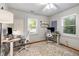 Spacious home office with dual workstations, ergonomic chairs, natural light, and hardwood floors at 324 Pine Ne St, Marietta, GA 30060