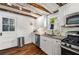 Updated kitchen with stainless steel appliances, granite counters, white cabinets, and white subway tile backsplash at 324 Pine Ne St, Marietta, GA 30060