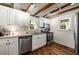 Charming kitchen with white cabinets, granite countertops, stainless steel appliances, and exposed wood beams at 324 Pine Ne St, Marietta, GA 30060